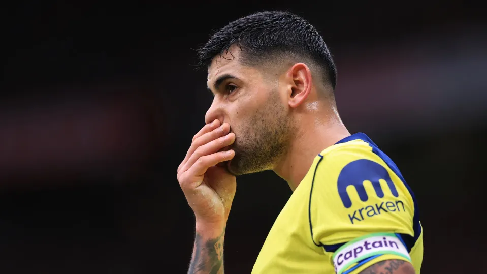 Cristian Romero of Tottenham Hotspur reacts after receiving a red card during the Premier League match between Manchester United and Tottenham Hotspur