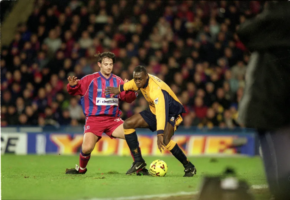 Emile Heskey of Liverpool is challenged by Craig Harrison of Crystal Palace during the Worthington Cup Semi Final First Leg match at Selhurst Park