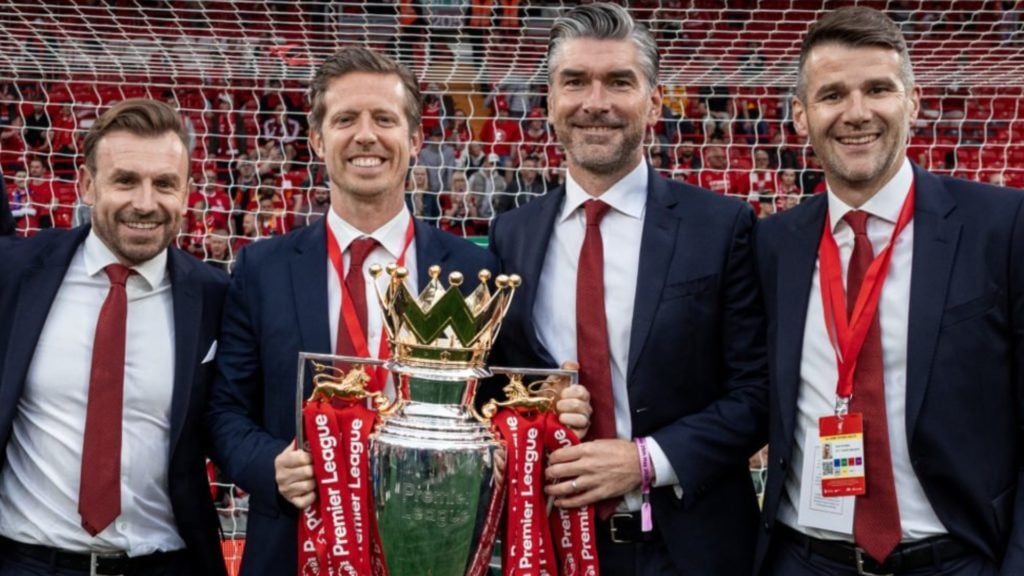 Michael Edwards and Richard Hughes pictured holding the Premier League title.