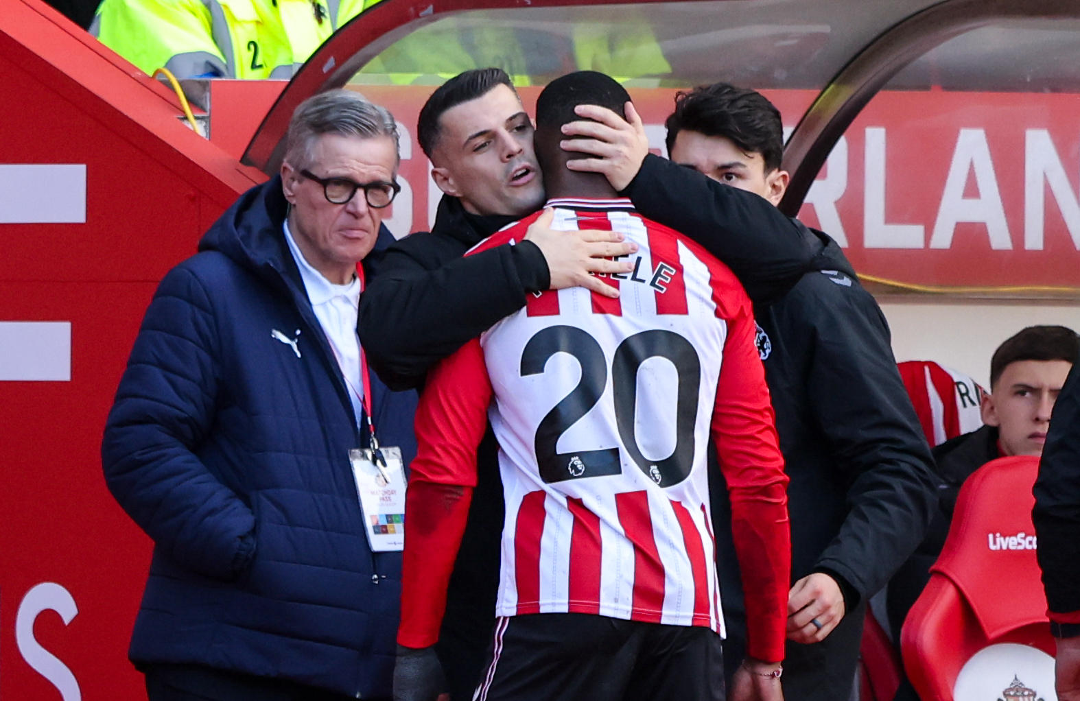 SUNDERLAND, ENGLAND - FEBRUARY 22: Sunderland’s Granit Xhaka hugs the injured Nordi Mukiele as he leave the field during the Premier League match between Sunderland and Fulham at Stadium of Light on February 22, 2026 in Sunderland, United Kingdom. (Photo by Alex Dodd - CameraSport via Getty Images)