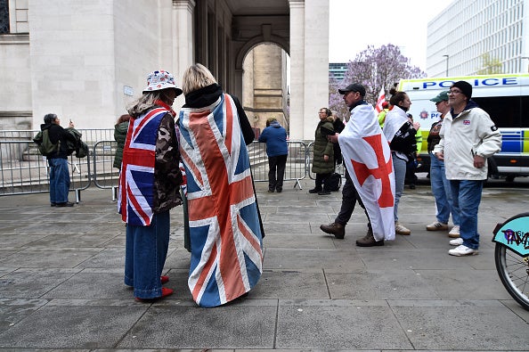 People wear Union Jack and St George's cross flags