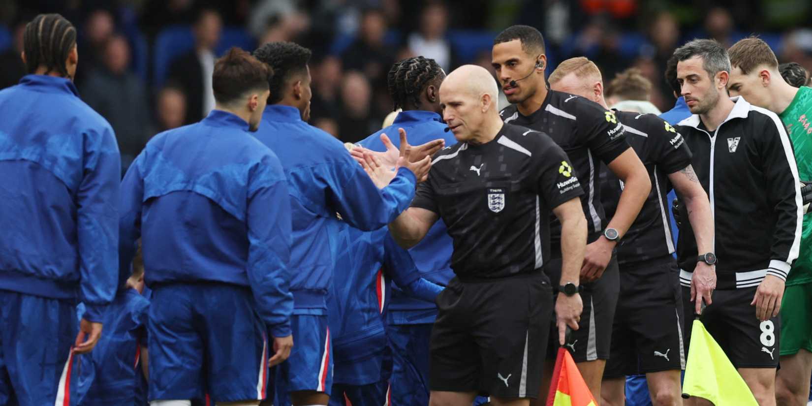 Linesman Richard West shakes hands during FA Cup Quarter Final between Chelsea and Port Vale