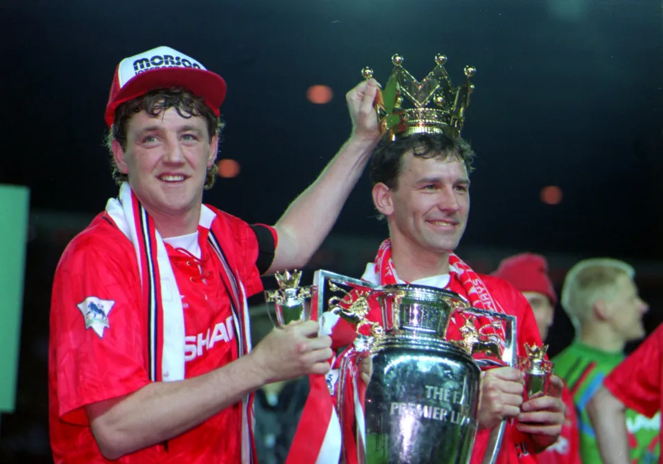 A PICTURE SHOWING STEVE BRUCE AND BRYAN ROBSON OF MANCHESTER UNITED SOCCER CLUB AS THEY RAISE THE CUP AFTER WINNING THE FA PREMIER LEAGUE HAVING BEATEN BLACKBURN ROVERS BY 3 GOALS TO 1