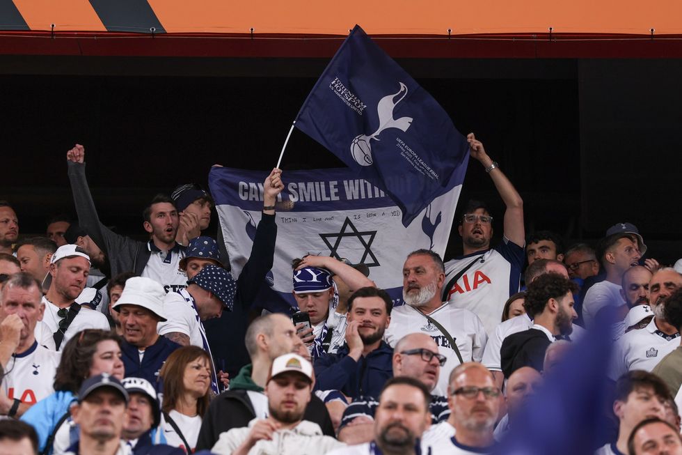 Spurs fans hold a flag bearing the Star of David aloft at the 2025 Europa League final