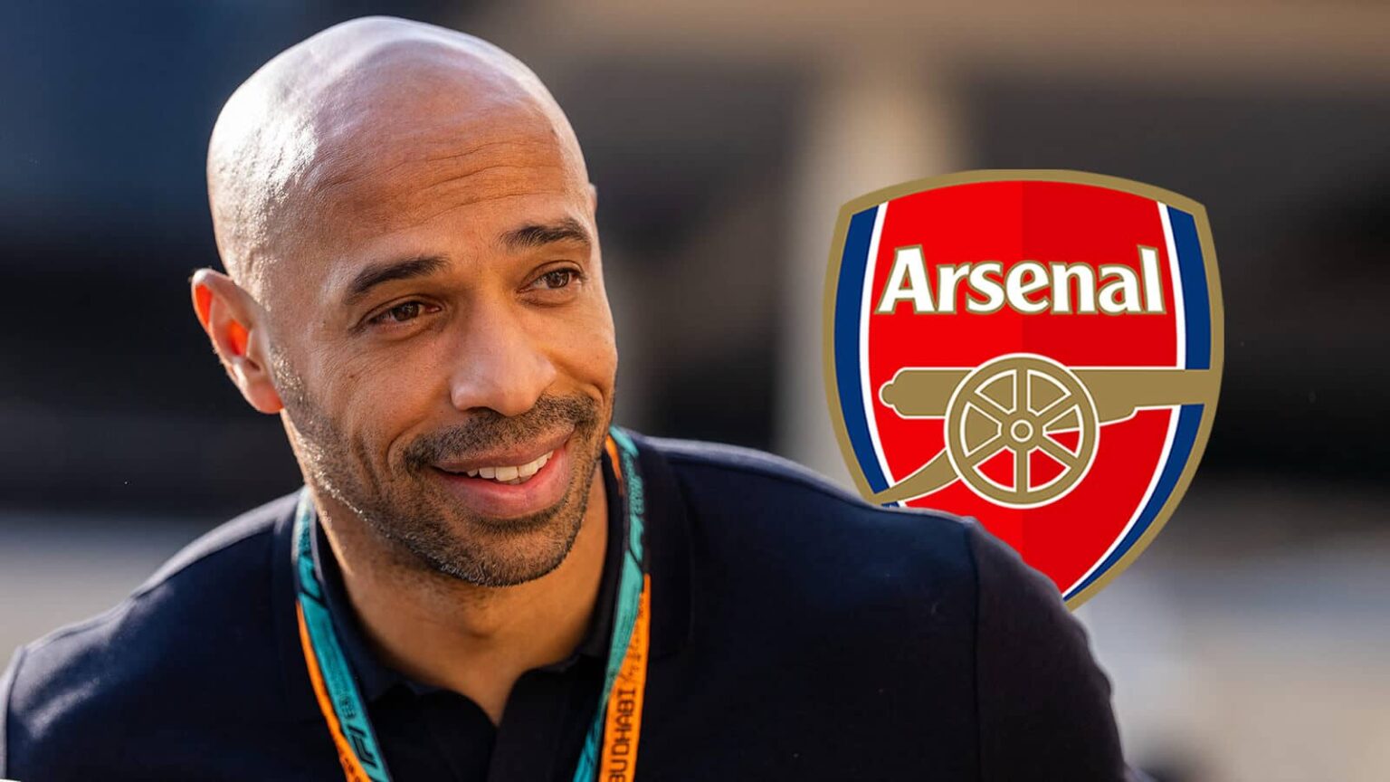 Thierry Henry with Arsenal badge