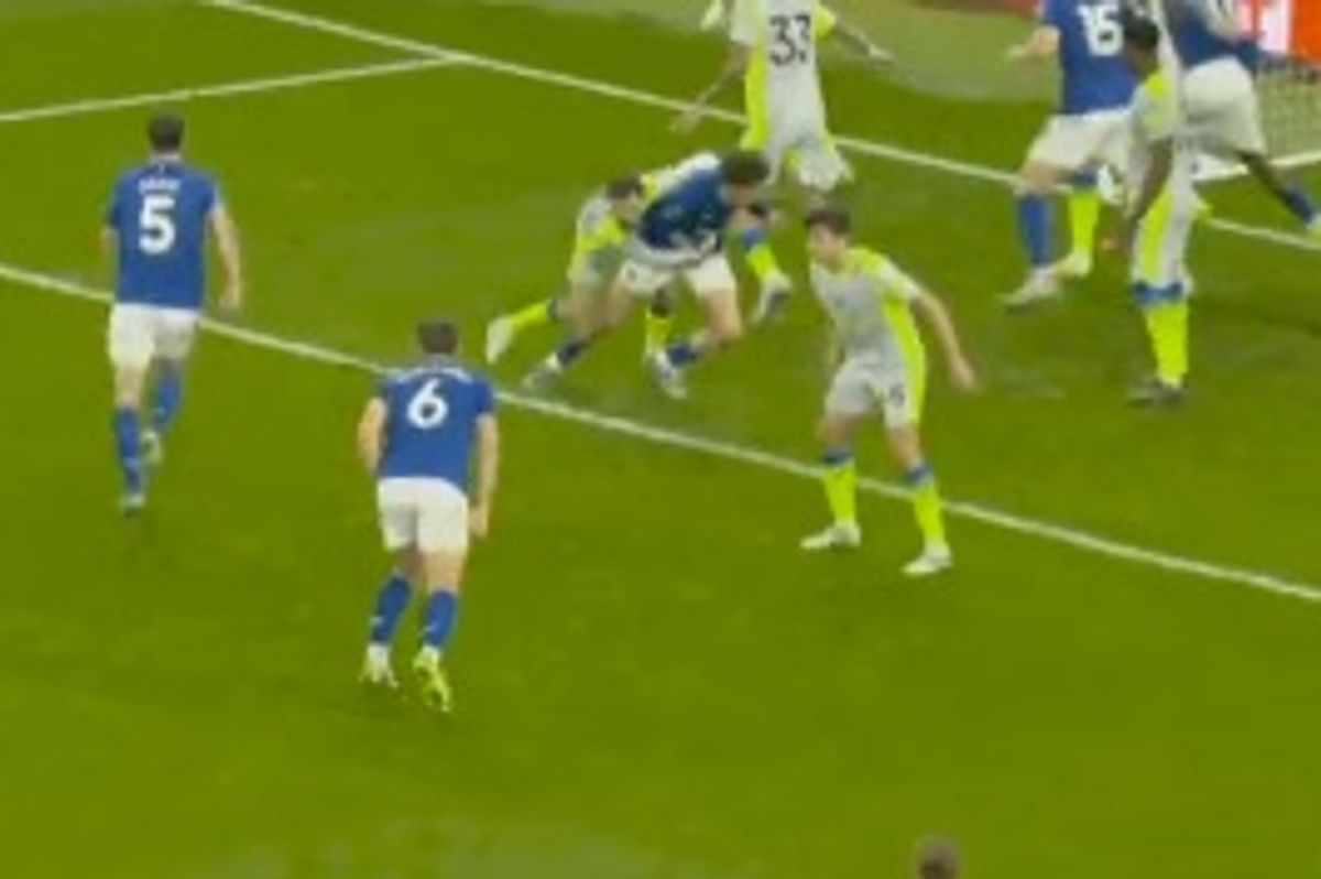 Merlin Rohl is dragged to the floor by Bernardo Silva