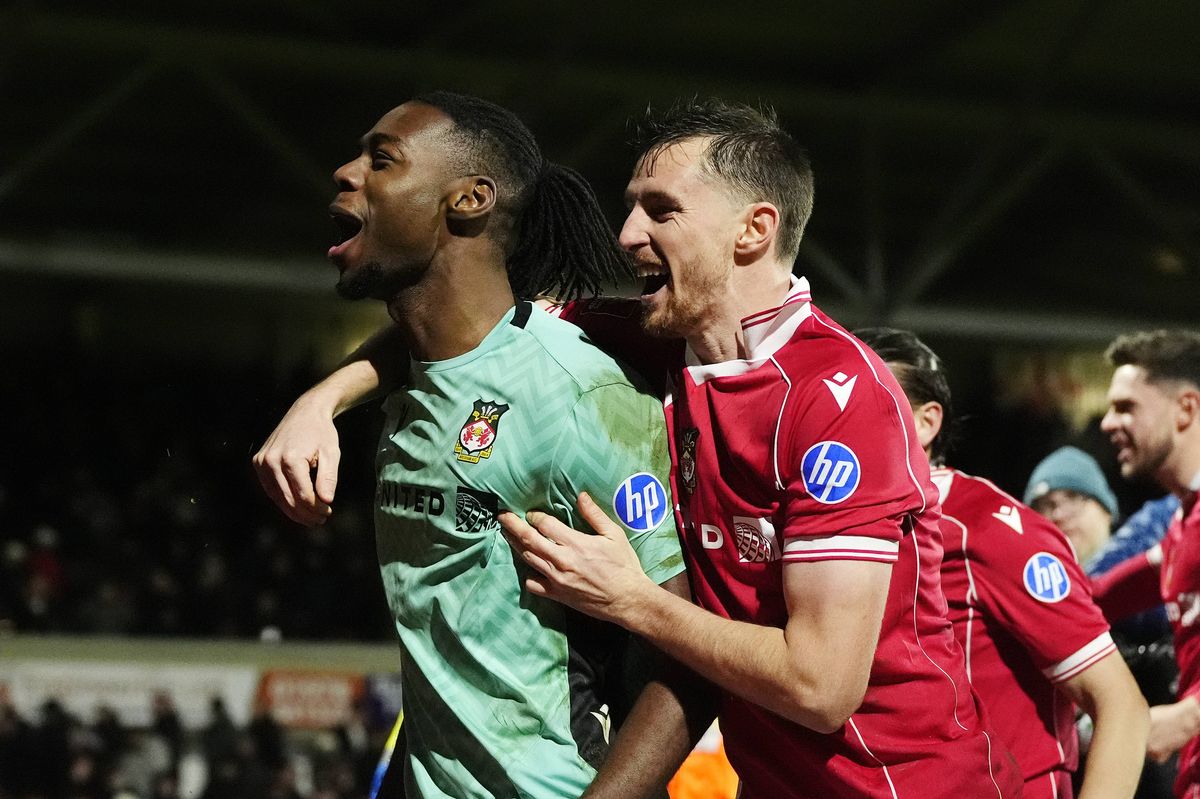 Wrexham goalkeeper Arthur Okonkwo celebrates after beating Nottingham Forest