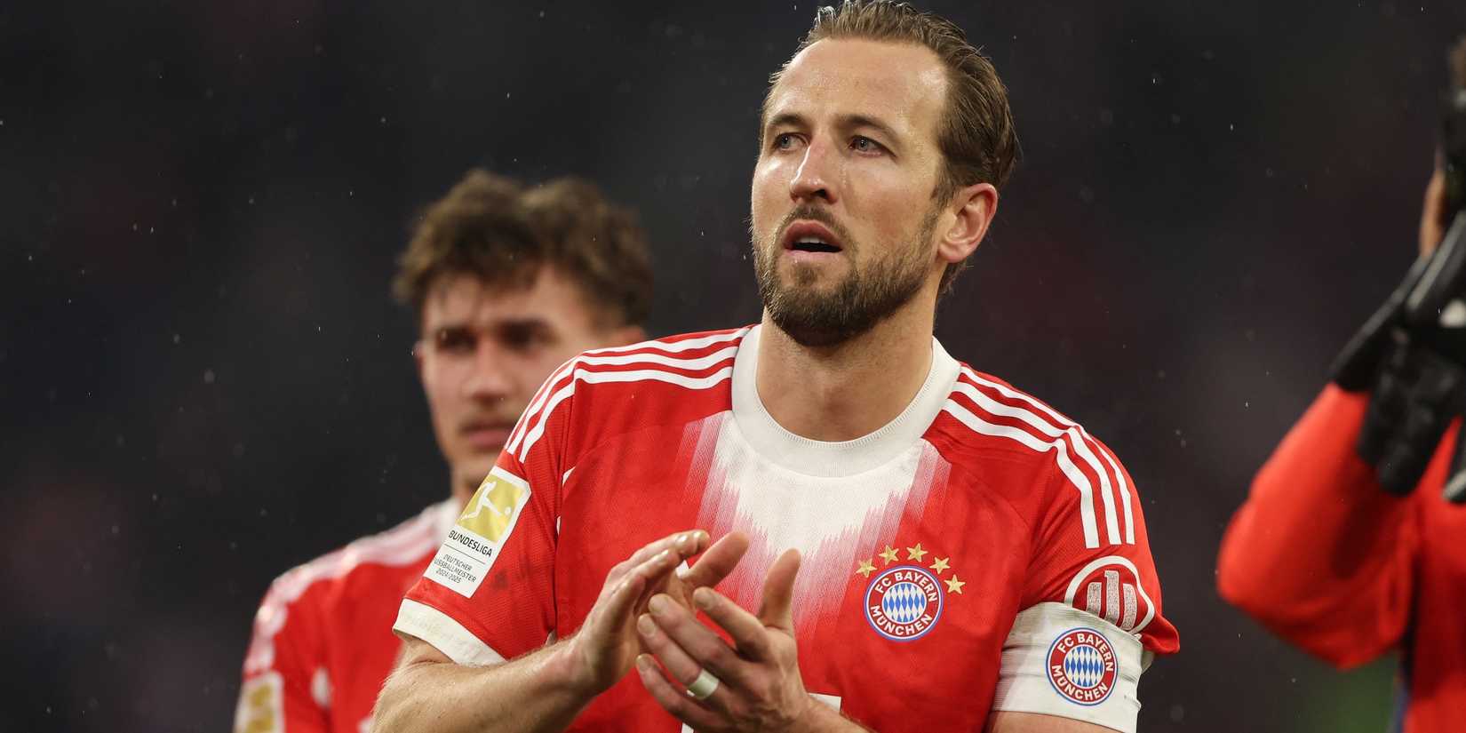 Bayern Munich's Harry Kane applauds fans after the match