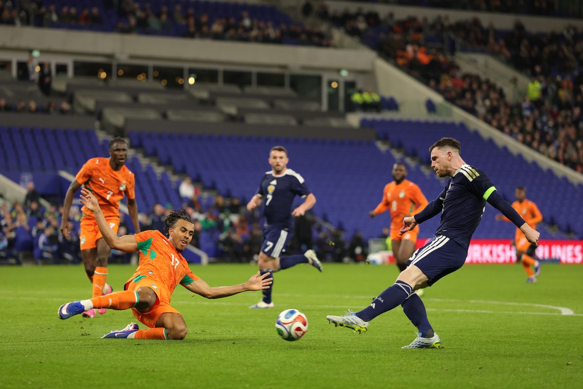 Andy Robertson takes a shot as Guela Doue slides in to block during the international friendly between Scotland and Ivory Coast at Everton's Hill Dickinson Stadium on March 31, 2026