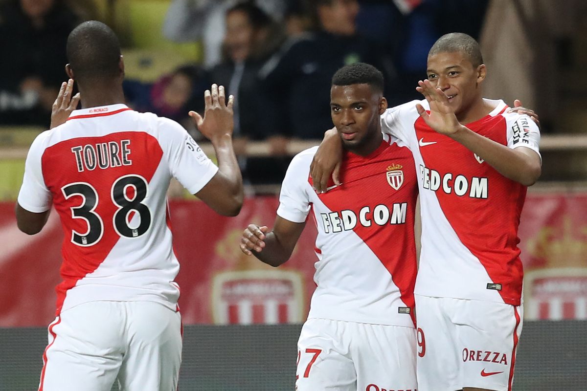 Monaco's French midfielder Thomas Lemar (C) celebrates with Monaco's French forward Kylian Mbappe (R) after scoring a goal during the French L1 football match Monaco (ASM) vs Bastia (SCB) on December 3, 2016