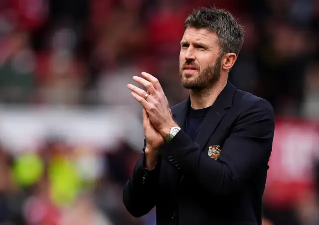 Manchester United manager Michael Carrick applauds supporters