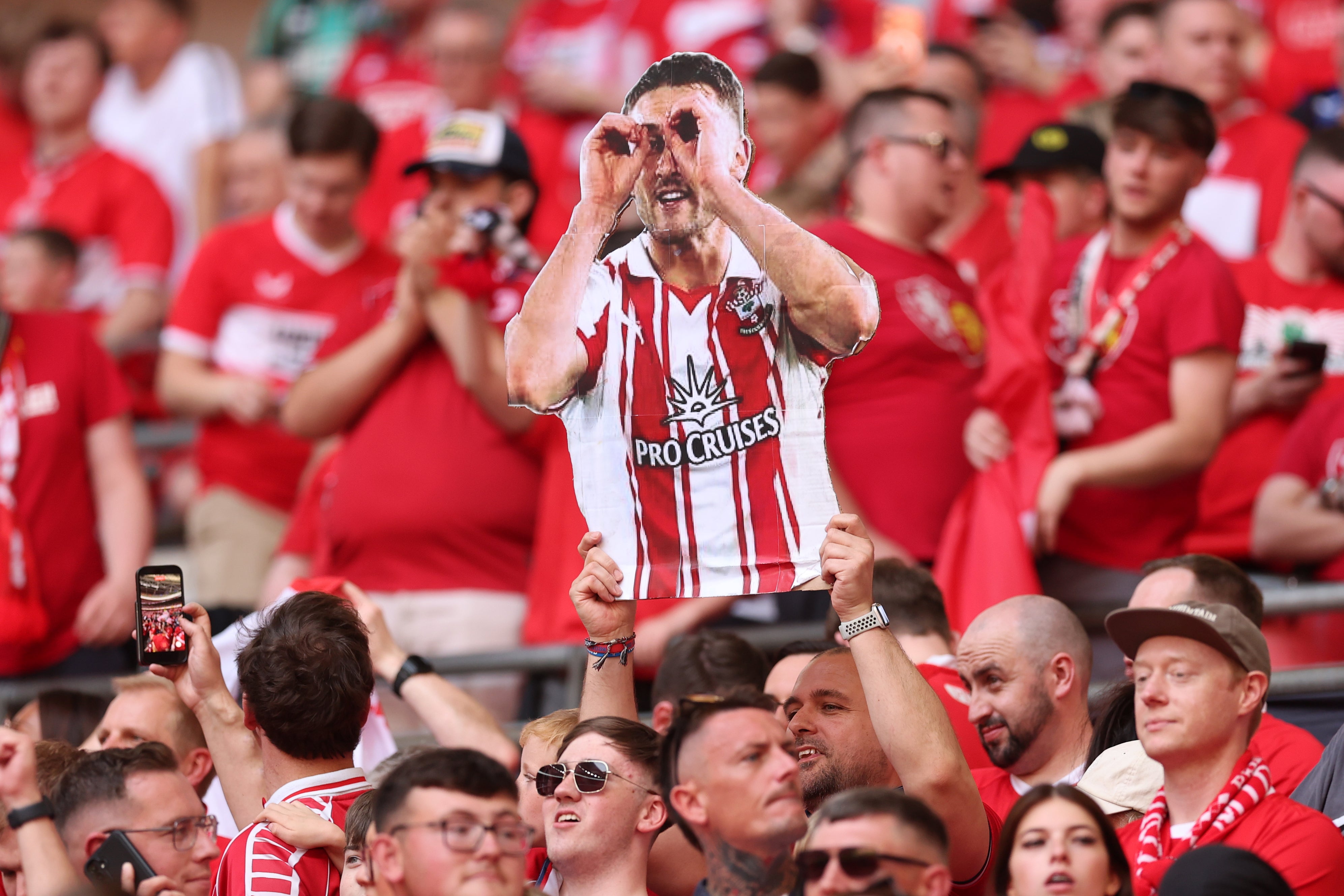 A Middlesbrough fan holds up a cutout of Southampton captain Taylor Harwood-Bellis during the Championship play-off final