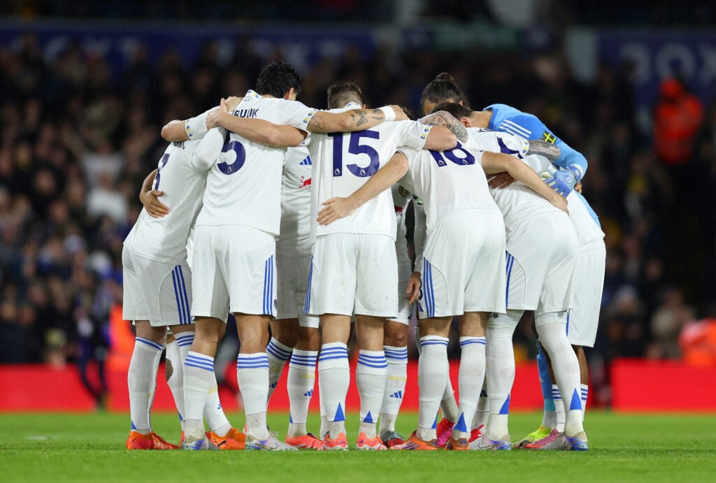 Leeds United players huddle before facing Liverpool