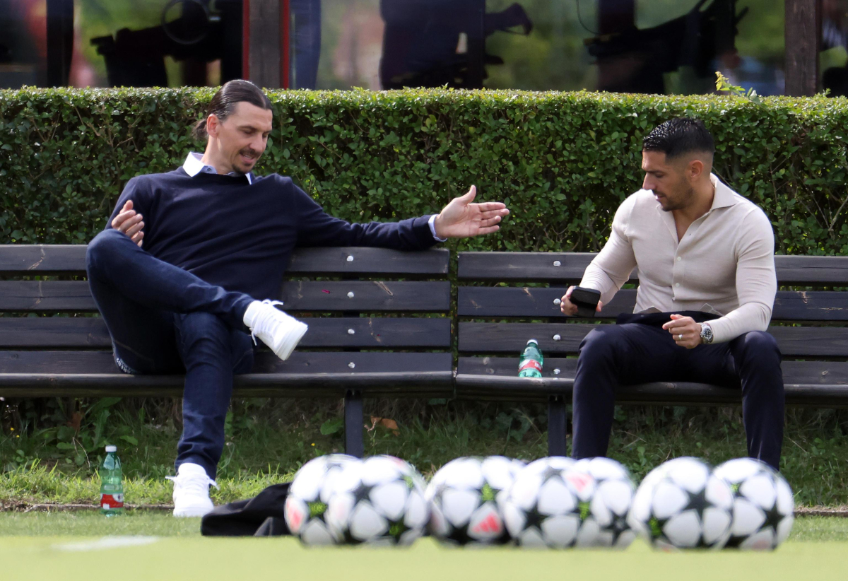 epa11607798 Former AC Milan forward Zlatan Ibrahimovic (L) and AC Milan chief scout Geoffrey Moncada watch the team's training session at the club's Milanello Sports Center in Canargo, Italy, 16 September 2024. AC Milan will face Liverpool in their first match of the UEFA Champions League 2024-25 season on 17 September 2024. EPA-EFE/MATTEO BAZZI